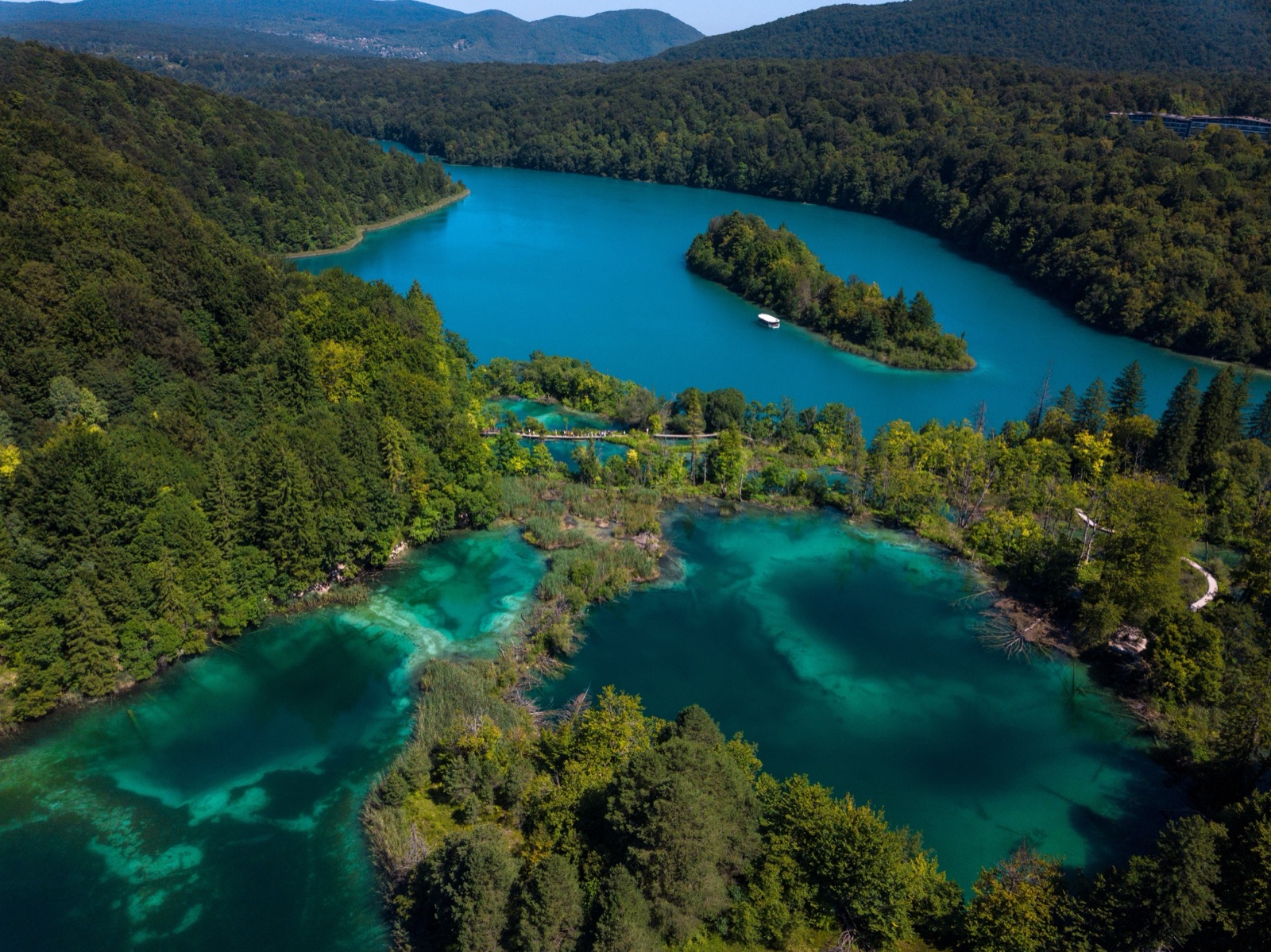 Aerial view of Plitvice's turquoise lakes among forested hills